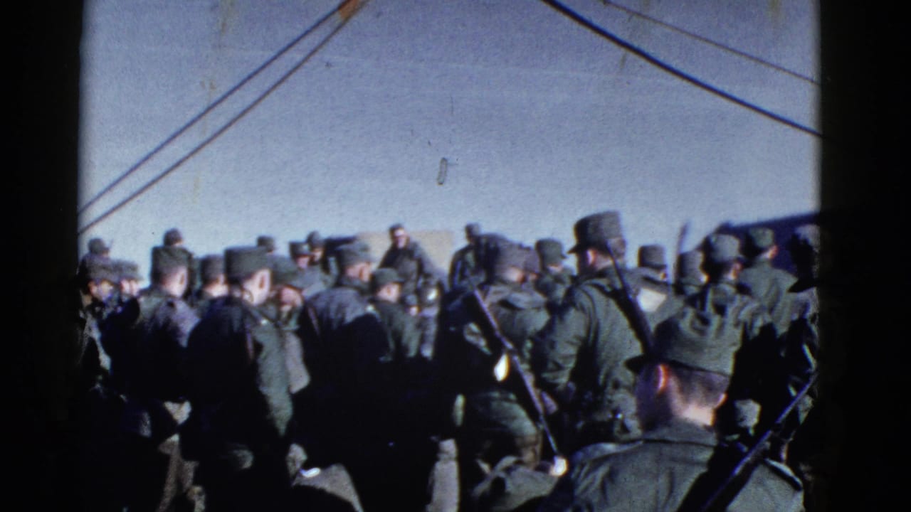 Uniformed men wait close together near a large vessel in 1952 San Francisco archival 8mm footage.
