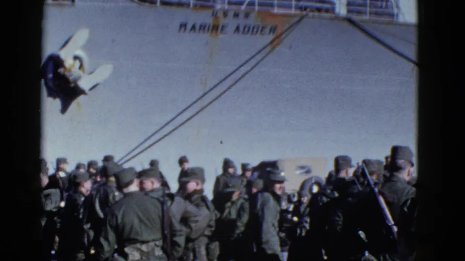 The ship name Marine Adder is visible above uniformed men gathered at the waterfront in 1952 San Francisco footage.