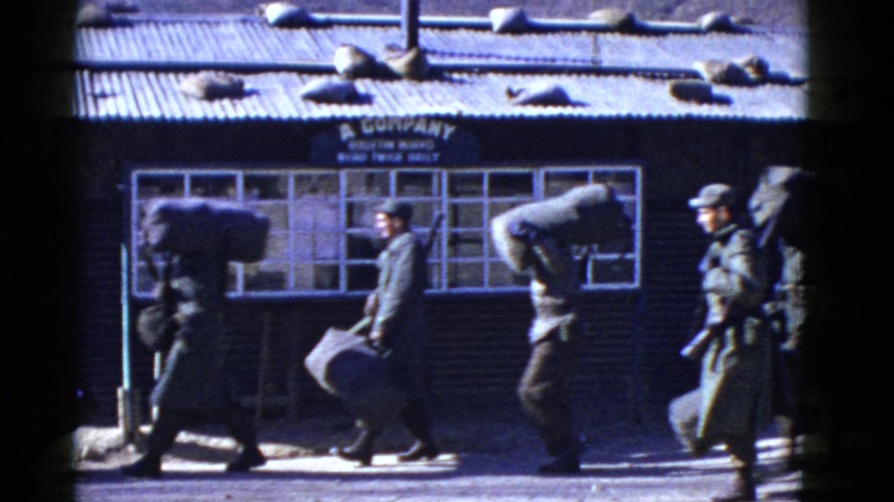 Uniformed military personnel in San Francisco walk with gear past a building sign reading A Company.