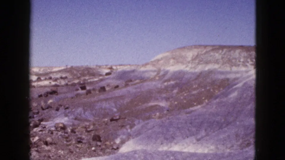 Vintage 1953 Arizona frame showing rolling, snow-dusted terrain with a pale ridge and no visible structures.