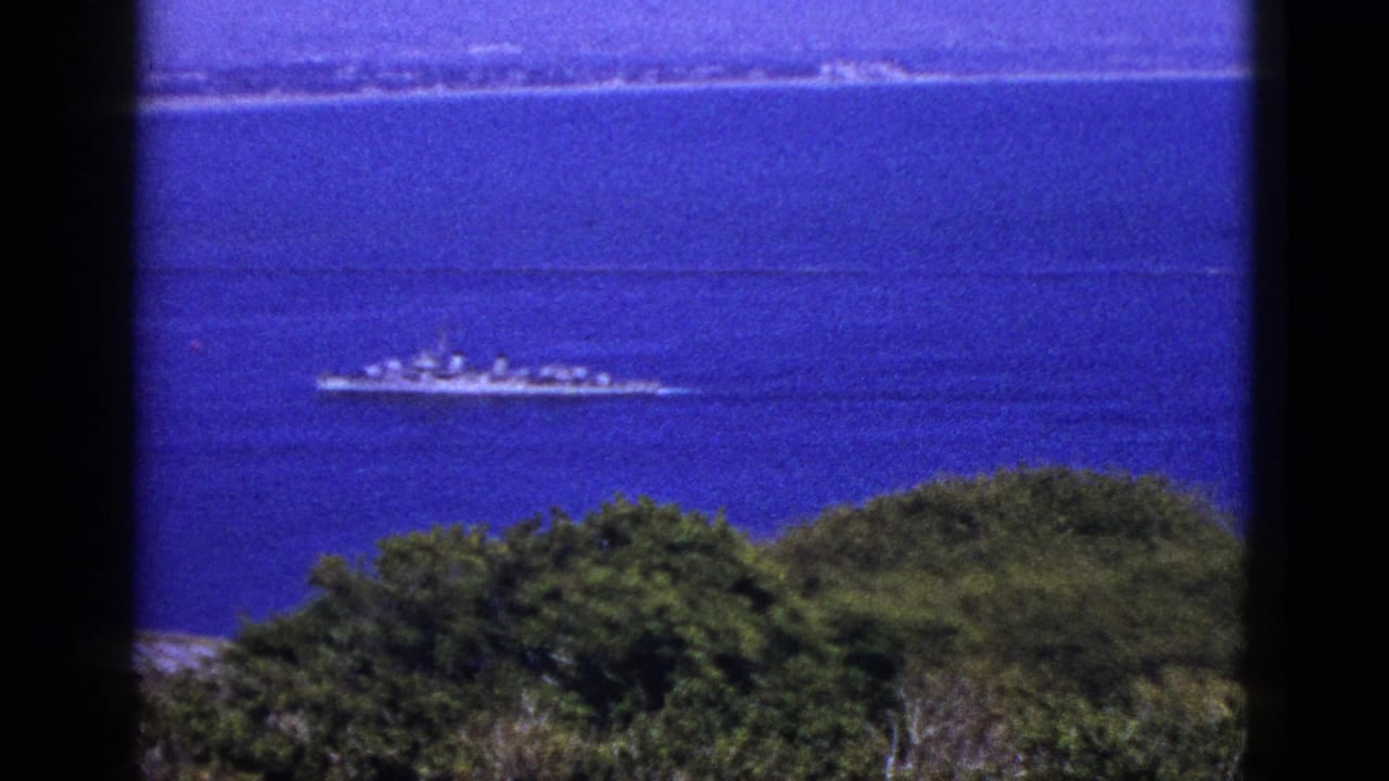 Another distant ship on blue water seen from a high viewpoint.