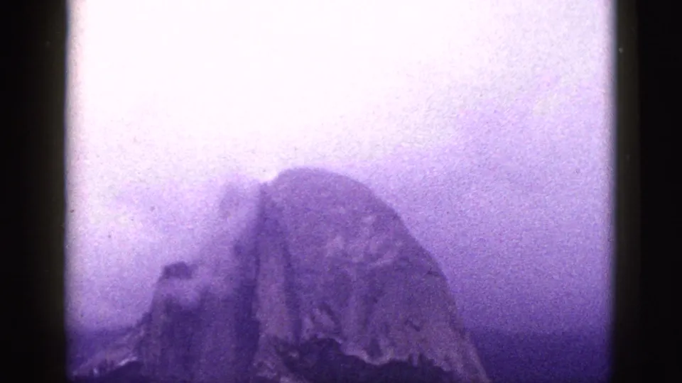 Final 8mm frame shows a misty rock formation in California, with the waterfall area softened by haze and aged color shift.