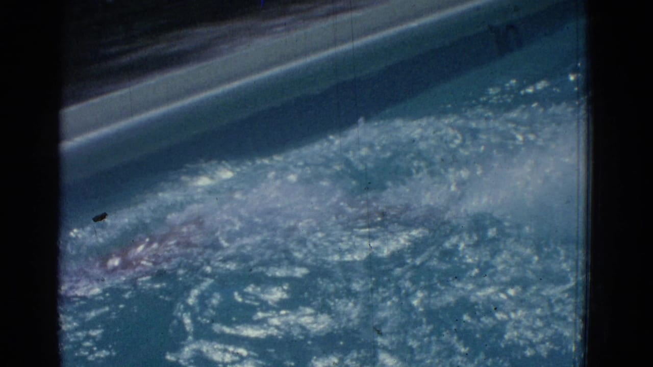 1953 Yonkers home-movie frame showing bright reflected sunlight on blue pool water beside the pool edge.