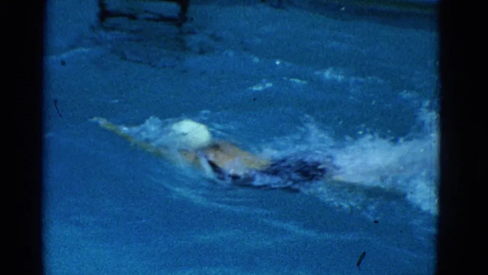 1953 Yonkers frame showing the swimmer stretched out in a freestyle lap across the pool.