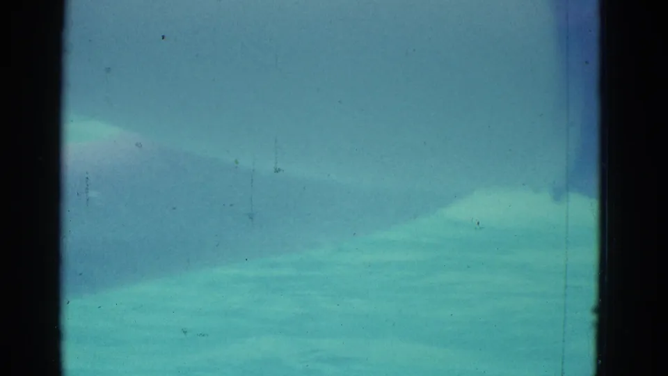 Final 1953 Yonkers pool frame with a faint submerged swimmer shape in blue-green water and visible 8mm borders.