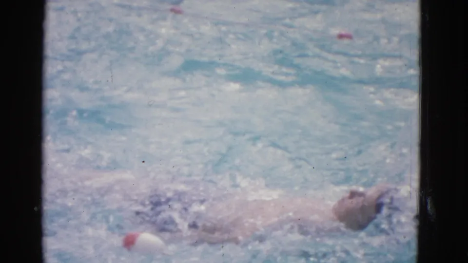 1953 Yonkers pool frame showing the swimmer stretched out in the water as the stroke carries forward.