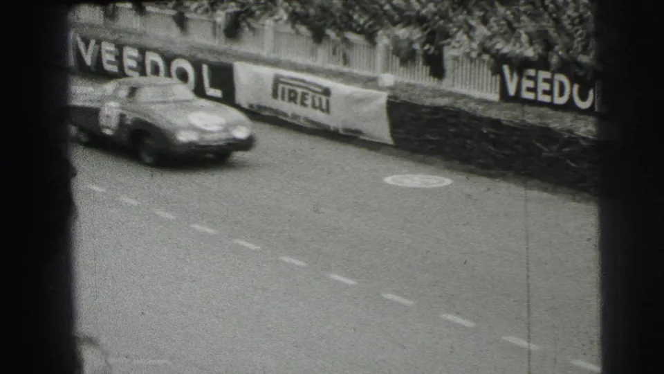 The final frame shows a race car moving past the Le Mans barriers, with spectators above and prominent Veedol and Pirelli signage.