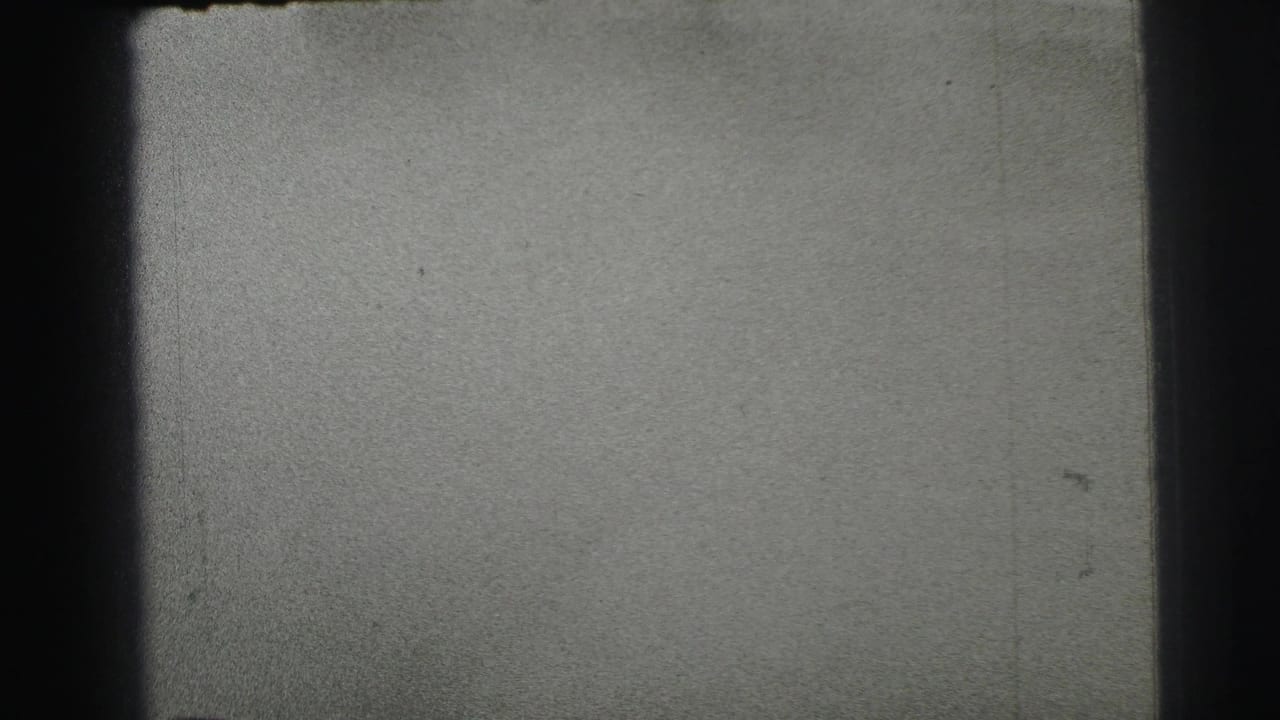 The final 1954 Le Mans frame shows a largely empty section of track, emphasizing grain, scratches, and black 8mm frame edges.