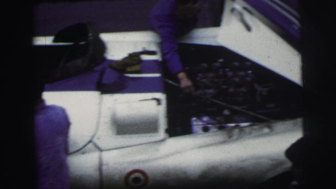 Open rear section of a race car with a mechanic partly visible nearby.