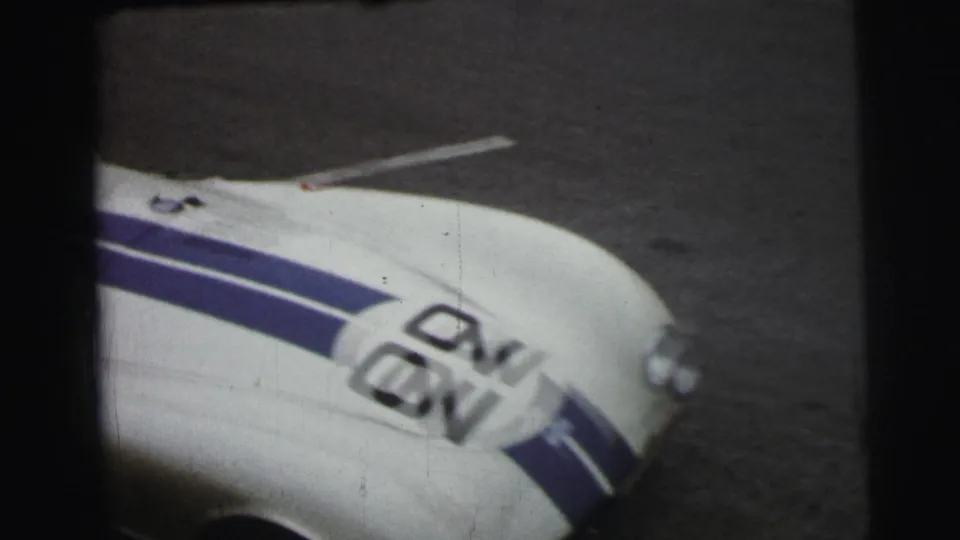 Close 1954 Le Mans view of the white racing car body with blue striping and number 92 partly filling the frame.