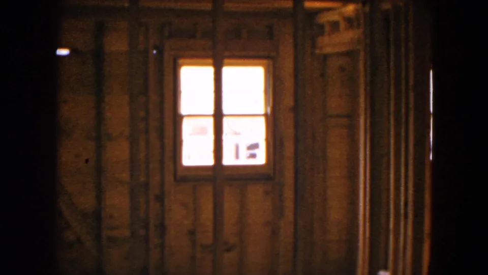 The final frame shows the unfinished Hicksville home interior with exposed studs, a bright window, and a dark doorway or wall edge.