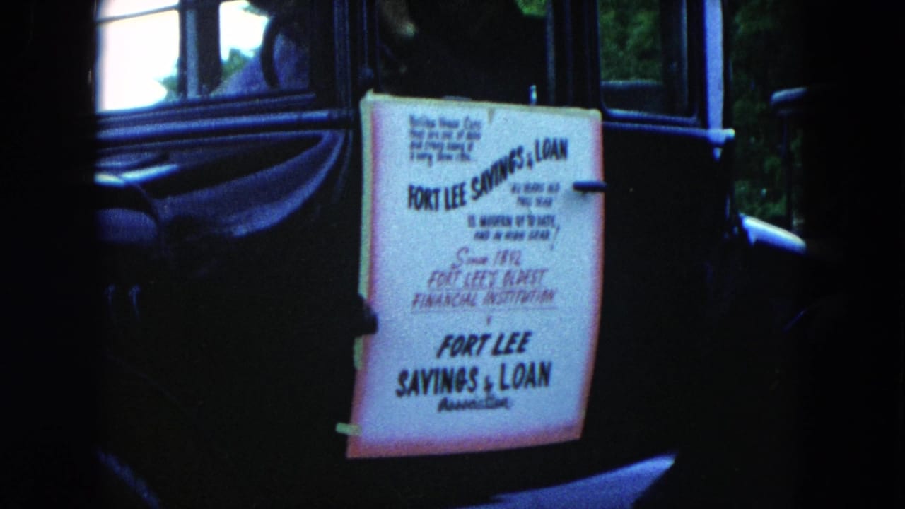Hand-lettered Fort Lee Savings & Loan sign taped to a dark car.