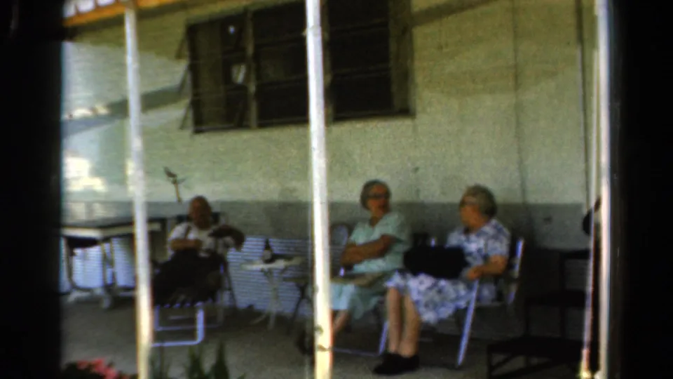 The final 1954 California frame shows three older women seated on a shaded porch, with posts, chairs, and table details visible.