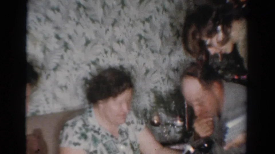 The Toledo holiday scene shows an older woman, a partially visible man, and a younger woman gathered near the Christmas tree.