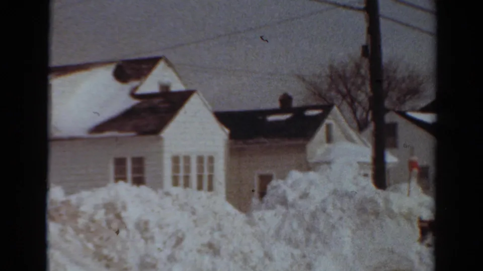 A 1954 Toledo winter street view shows clapboard houses, heavy snowbanks, utility wires, and a pole in the foreground.