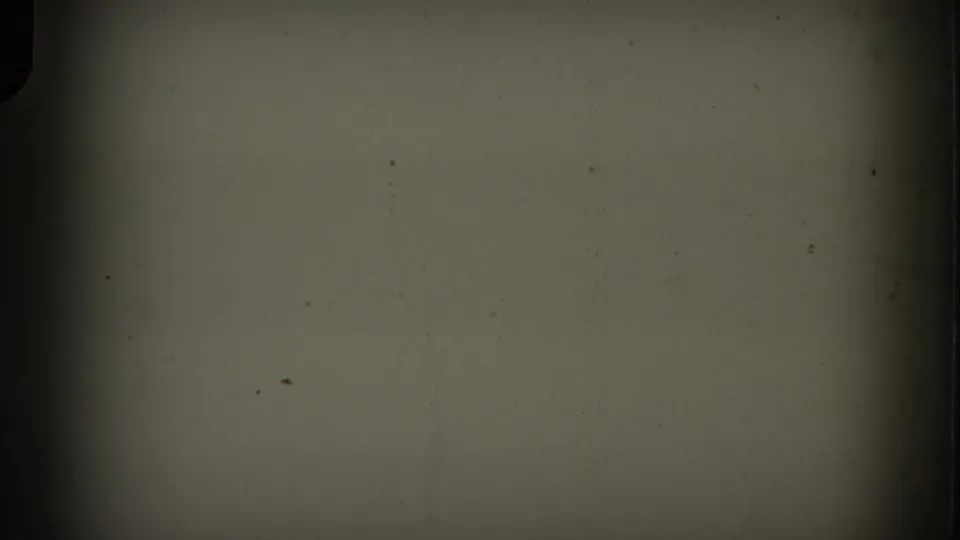 Opening 8mm frame with a dark border, muted blank exposure, and visible dust before the New York aerial view appears.