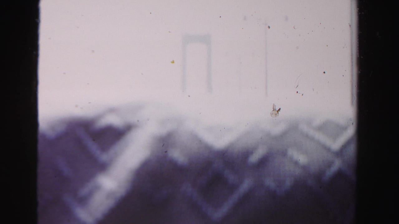 Another hazy 1955 Dade County frame showing the bridge structure through aged 8mm film texture.