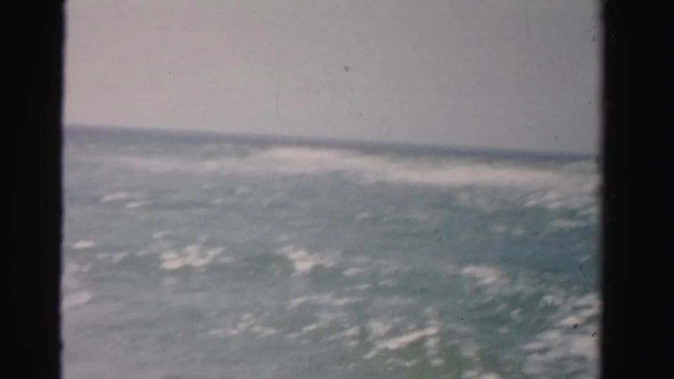 1955 Dade County, Florida 8mm frame looking across rough ocean water toward a hazy horizon line.