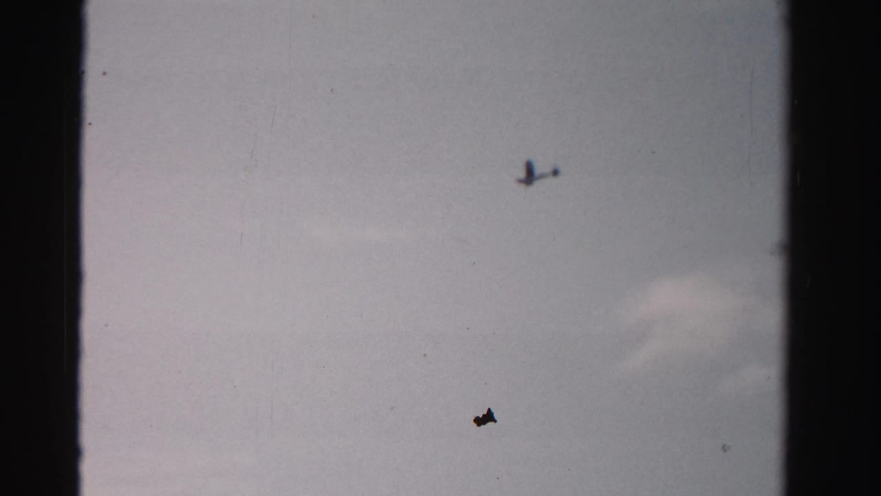 Tiny airplane silhouette near the upper right of a pale sky.