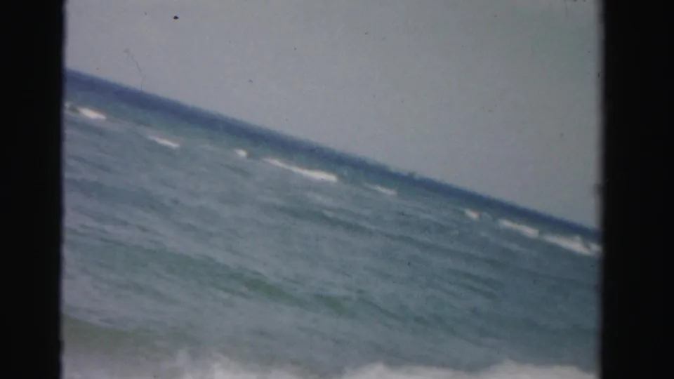 A tilted 8mm frame shows choppy ocean water and whitecaps off the Dade County shoreline.