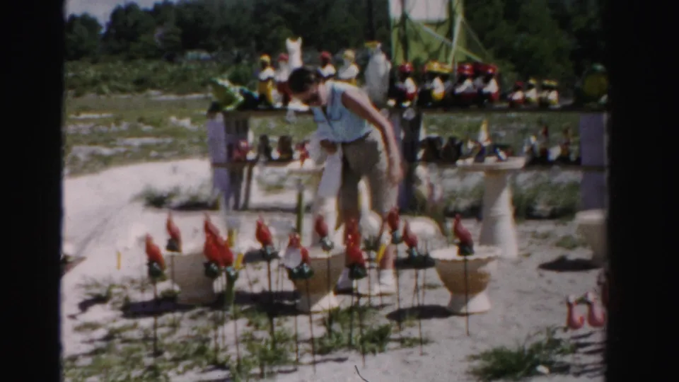 In the final frame, the woman bends toward red flamingo-like lawn ornaments with more ceramic animals and outdoor displays behind her.