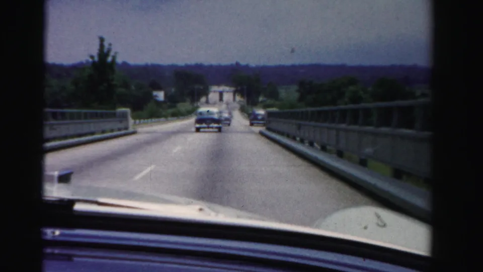 Final frame shows a first-person road view on a bridge in Dade County, Florida, with a sedan ahead, another vehicle farther right, railings, and trees.