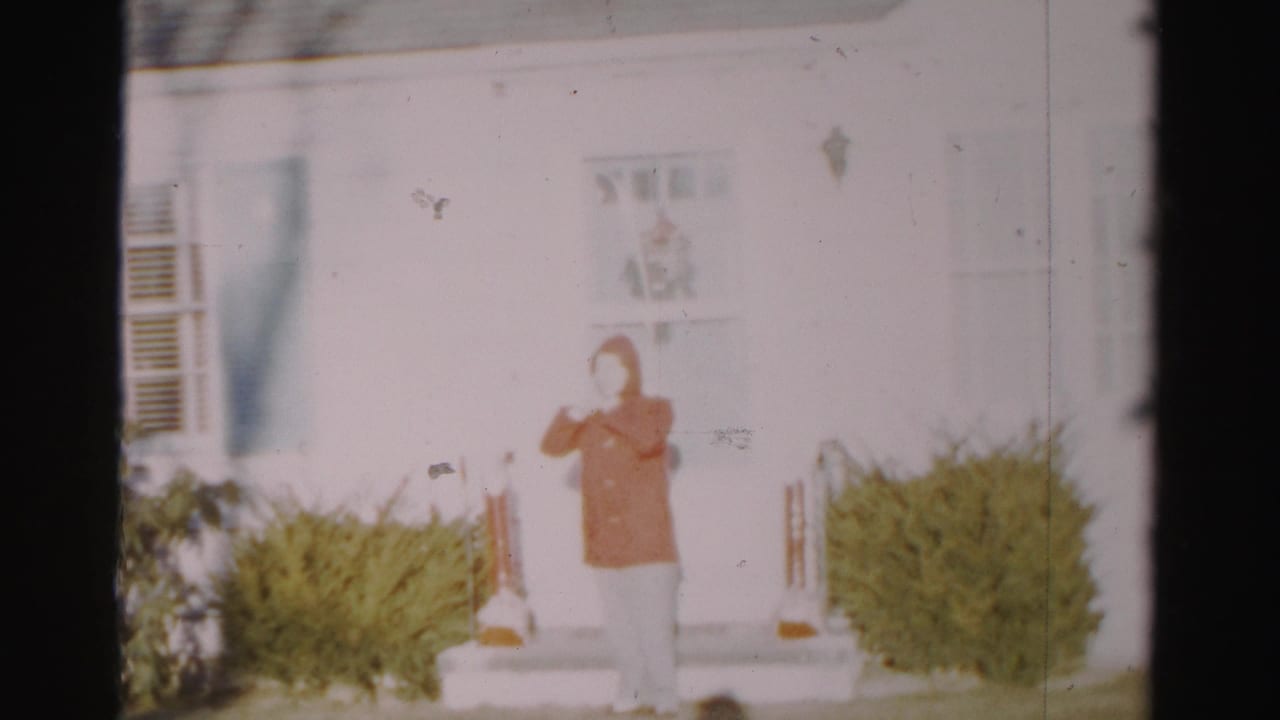 The final frame shows the red-coated person on the front steps of a white Albany house, with shrubs and railings visible.