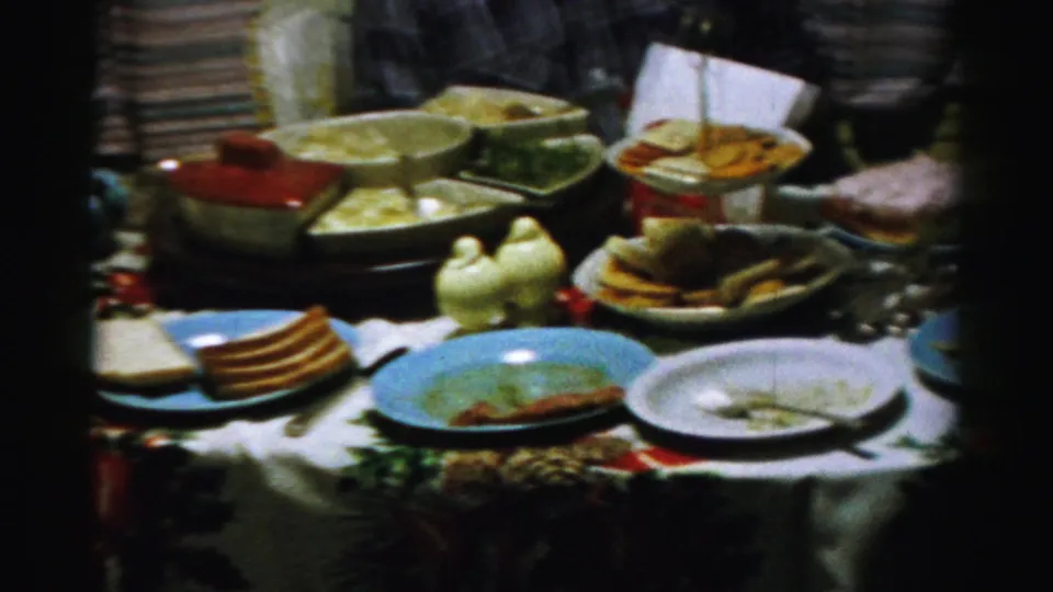 A 1956 Albany tabletop view shows plates, leftovers, serving bowls, and a partly visible person at the edge of the frame.