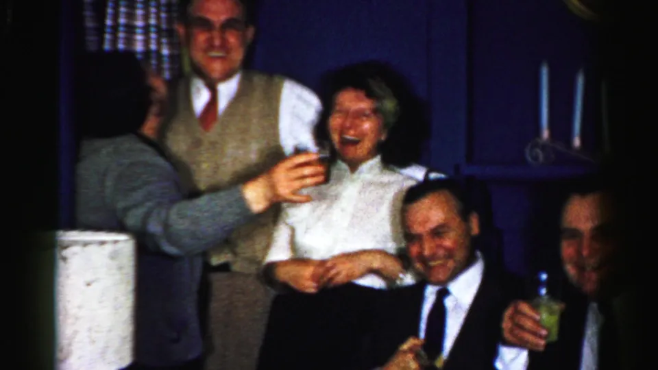 The final 1950s Albany frame shows multiple adults laughing indoors, with glasses raised or held and a crowded private-room party atmosphere.