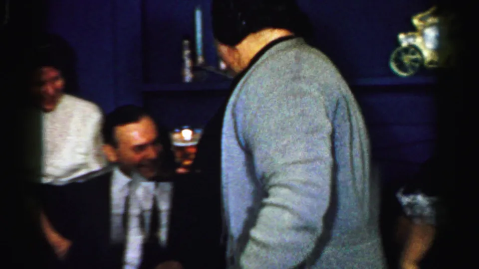 The closing Albany party frame shows adults in a private interior, including a man in a vest holding a drink and another figure seen from behind.