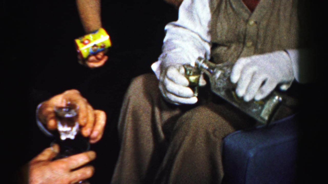 Close view of guests with a drink glass, bottle, white gloves, and snack package.