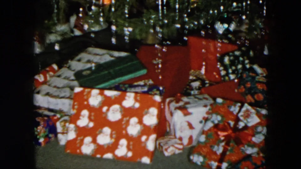 Final frame of a steady 8mm home movie shot showing a gift pile beneath a Christmas tree, Hicksville, New York, 1956.