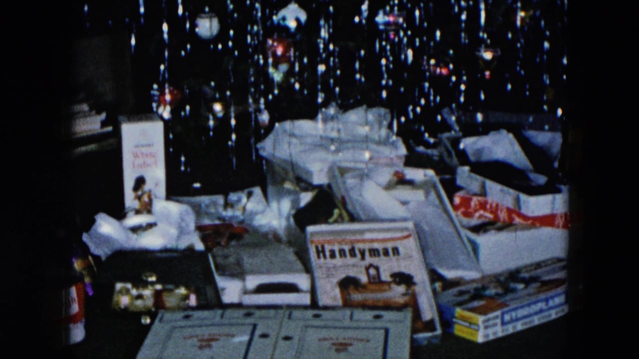 Christmas gift pile with Handyman magazine and open boxes beneath a tinsel-draped Christmas tree