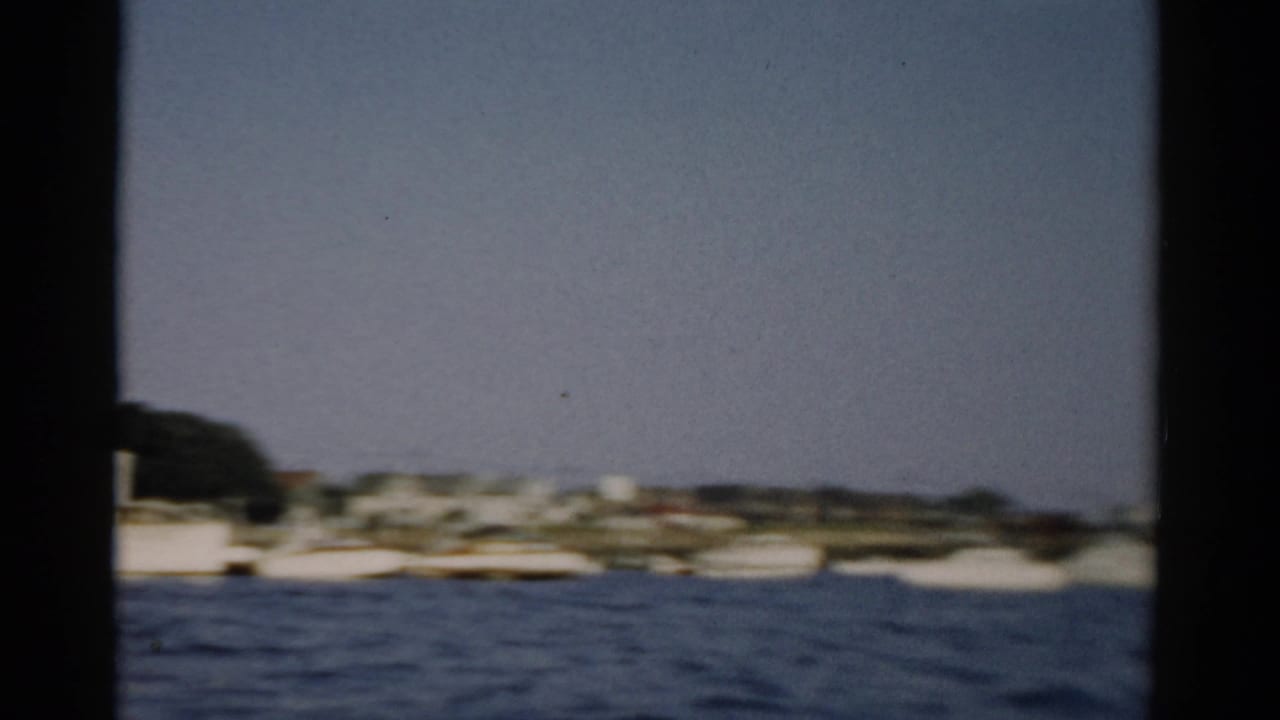 Catskill, New York harbor area, c. 1957 — open water and distant shore filmed through a window frame on 8mm color film.