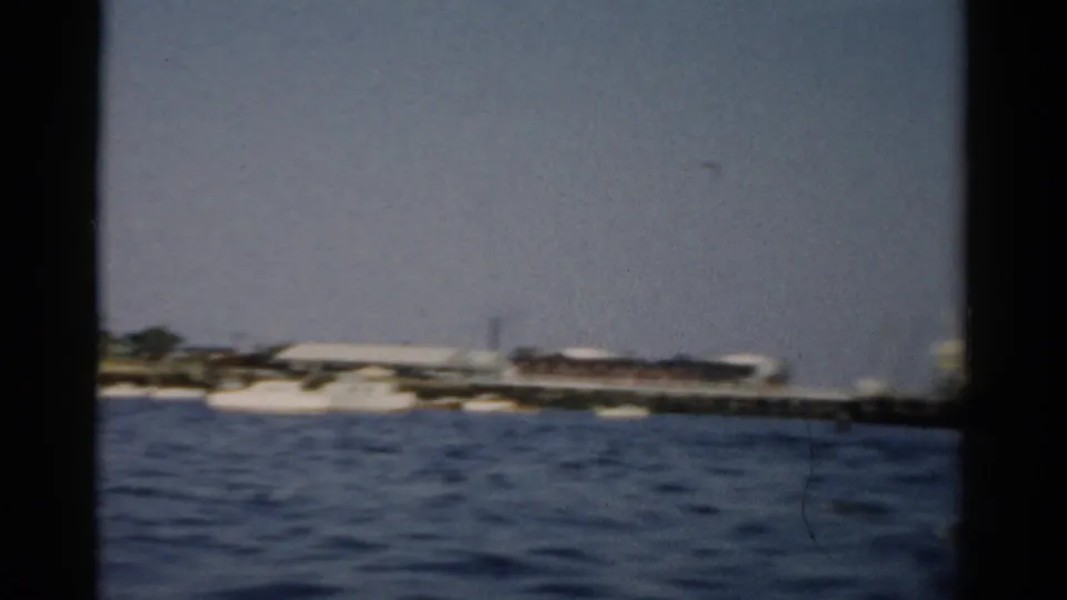 Harbor view from a boat or window, Catskill NY area, c. 1957 — distant shore and calm water on 8mm color film.