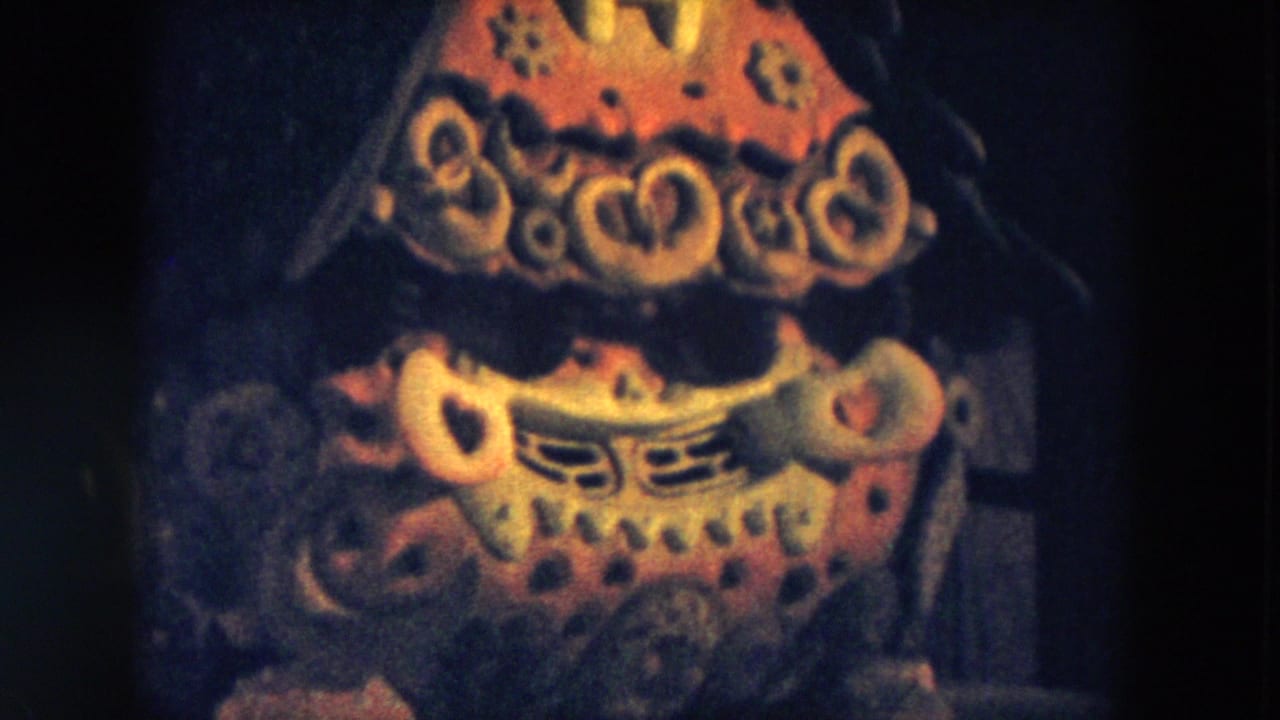 Close view of the abstract display with red and yellow patterned forms in darkness.