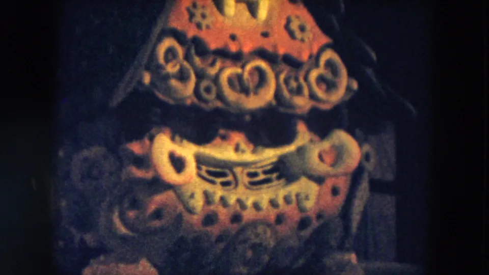 1957 Hicksville 8mm frame of the same abstract display, showing layered red, yellow, and orange shapes against a dark setting.