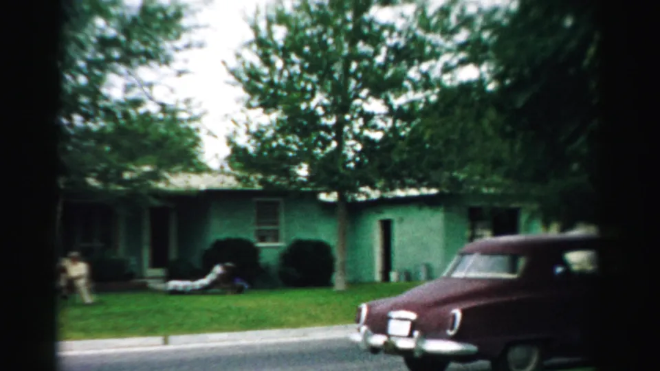 The final 1957 frame shows a maroon car passing the green house in Normal, Illinois, with adults still visible on the lawn.