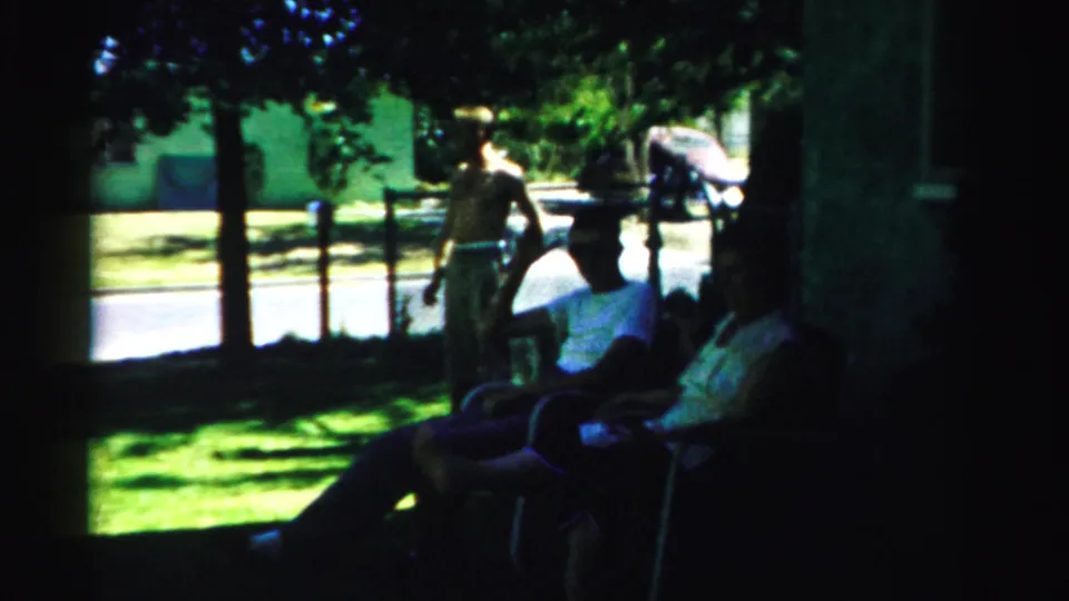 The final frame shows the man and leashed dog near seated neighbors under trees, with a porch edge and residential street visible.