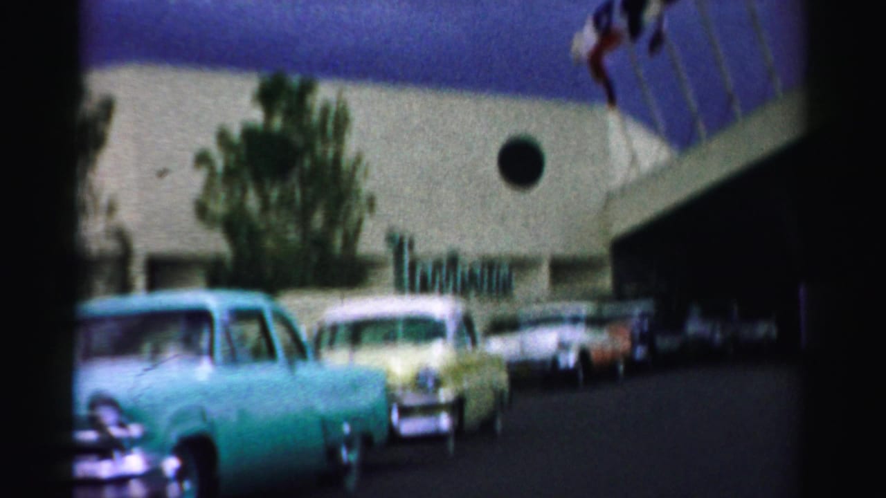 Turquoise and yellow cars lined up near the Tropicana hotel exterior.