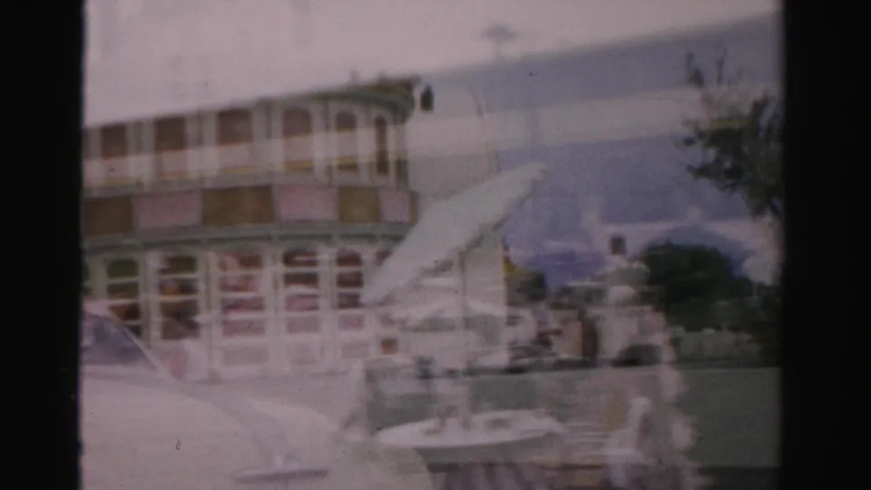 1957 Las Vegas poolside home-movie frame with lounge chairs, people on the deck, and a fading overlay of resort architecture.
