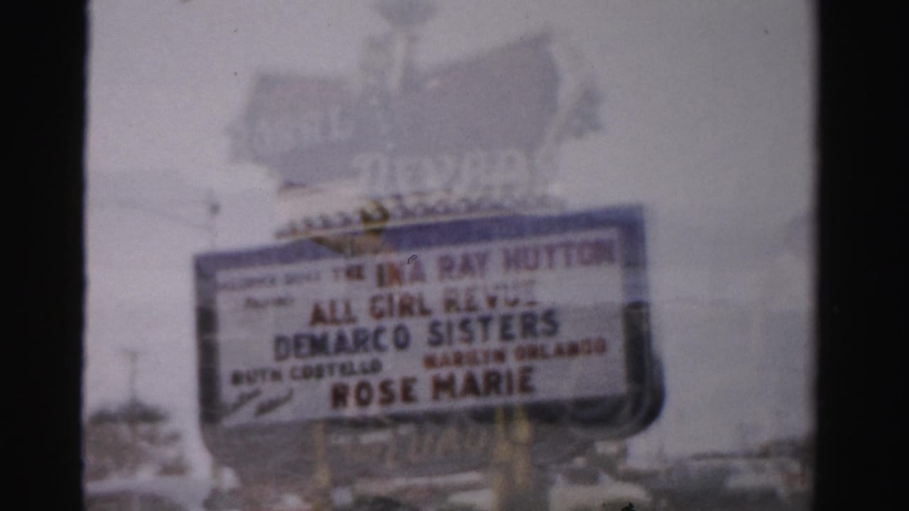 1957 Las Vegas frame centered on the Royal Nevada marquee, with entertainment billing visible through soft 8mm focus.