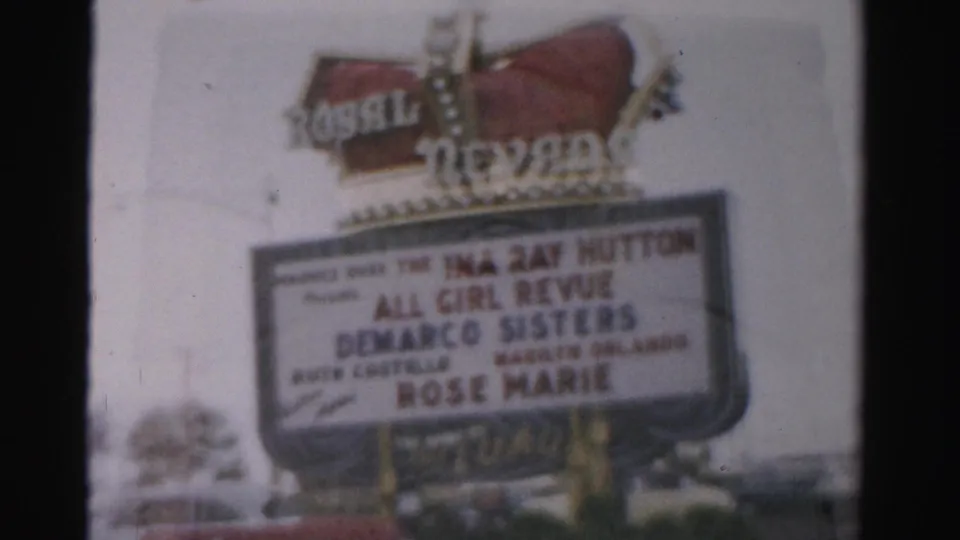 1957 Las Vegas home-movie frame of the Royal Nevada marquee, with show lettering and partial parked cars at the bottom.