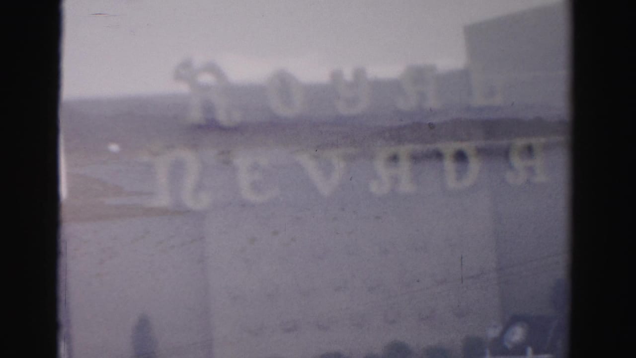 Blurred Royal Nevada sign lettering across a low building exterior.