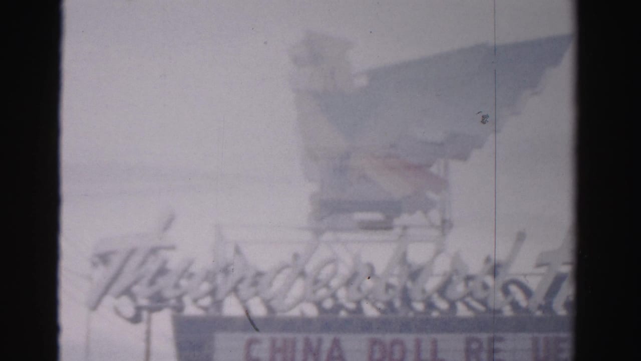 Soft 8mm frame of the Thunderbird Hotel sign with China Doll lettering partially visible.