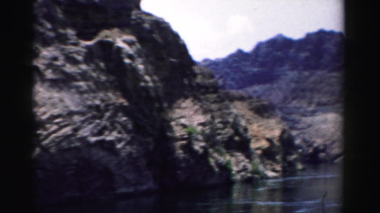 Rocky canyon walls and dark water below the Hoover Dam area.