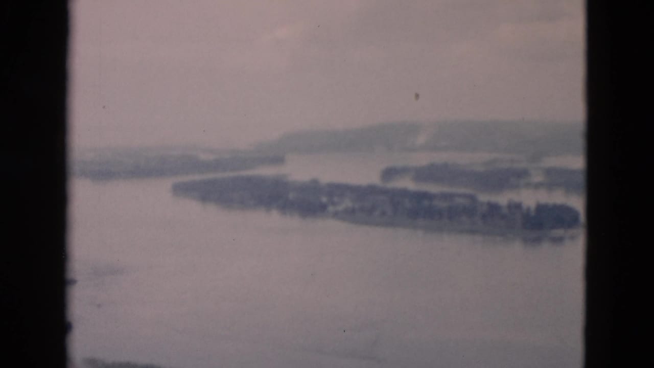 Broad water view with island shapes and hazy hills beyond.