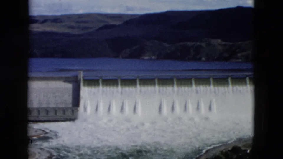 Montana 1958 8mm frame with the dam spillway closer in view and foaming water filling the lower frame.