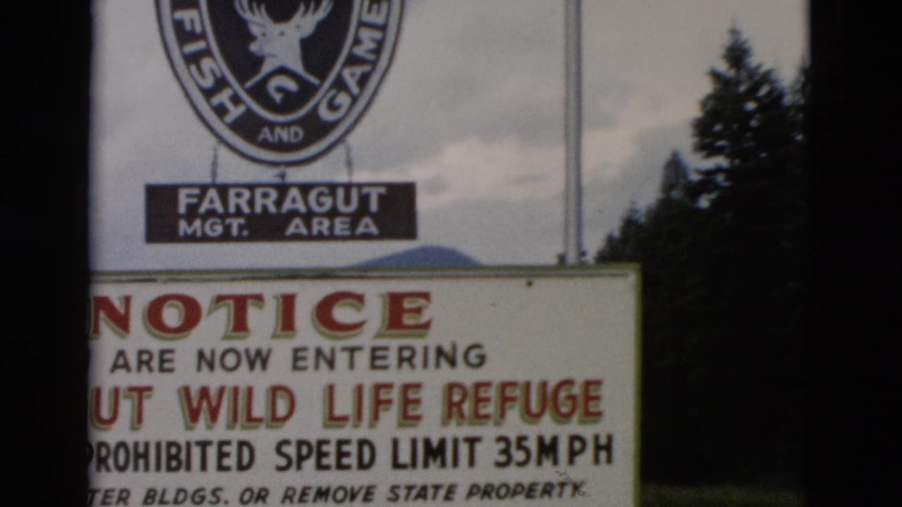 Close view of Farragut Wild Life Refuge notice, partly blocked by film-frame edge.