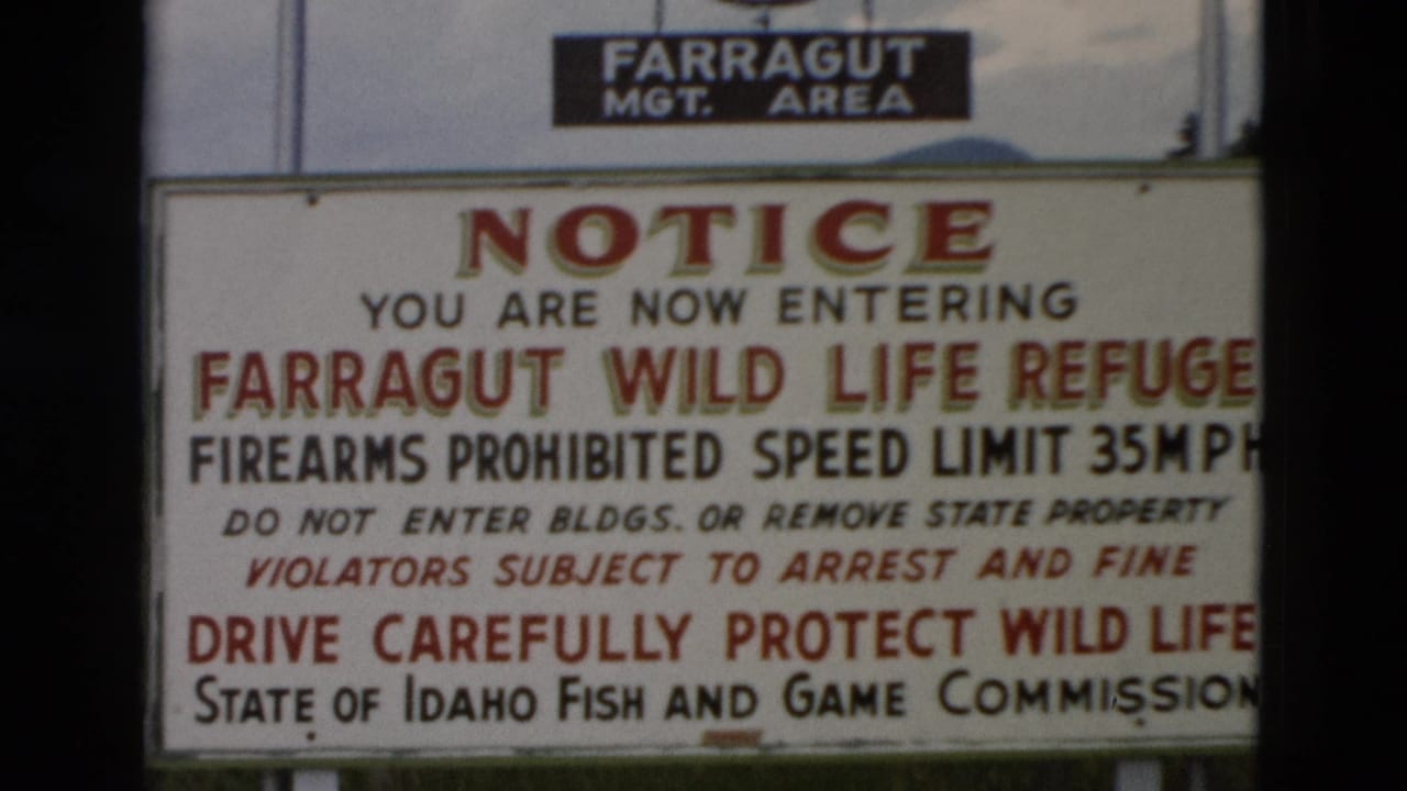 1958 8mm frame showing a close view of a Farragut Wild Life Refuge entrance notice with firearms and speed-limit rules.